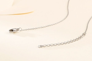 Detailed close-up of the silver metal lobster clasp and adjustable extension chain