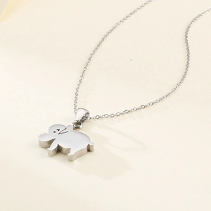 Minimalist silver elephant pendant necklace set on a clean beige background with soft light