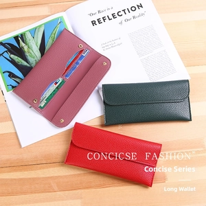Detail of soft leather long wallets with multiple card slots and litchi grain texture
