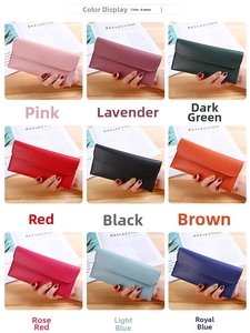 Litchi pattern long wallets for women in nine vibrant colors on a wooden table