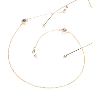 Golden eyewear chain featuring multi-colored evil eye charms and anti-slip silicone loops
