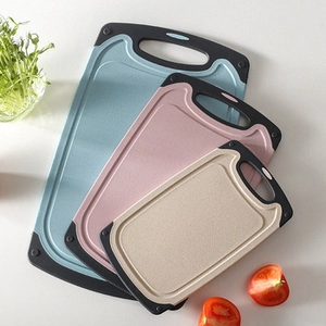 Macro detail of wheat straw cutting boards in 3 colors with non-slip handles and feet