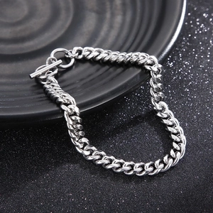 Macro shot of silver stainless steel Cuban link chain necklace with detailed OT toggle clasp