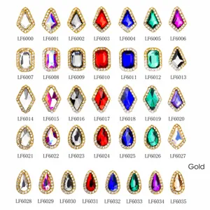 Detailed catalog of 35 assorted gold-framed nail gems in teardrop and rhombus shapes