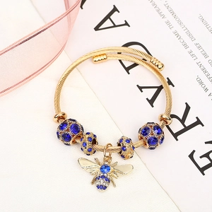 Adjustable gold titanium steel bee bracelet with sparkling blue and clear crystals
