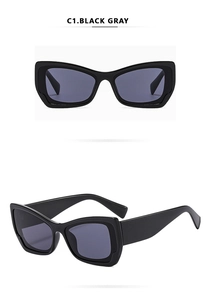 Detailansicht der schwarzen Cat-Eye-Sonnenbrille mit grauen Gläsern und breiten Bügeln