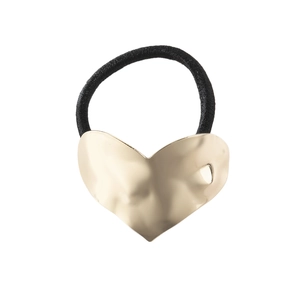 Close-up of golden hammered heart charm on black elastic hair tie for women