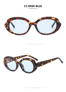 Detail view of oval retro sunglasses in demi frame with translucent blue lenses