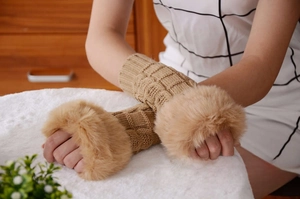 Close-up of khaki cable knit fingerless gloves with fluffy faux fur cuffs for winter