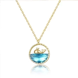 Elegant gold whale necklace with blue gemstone pendant and whale tail motif for women