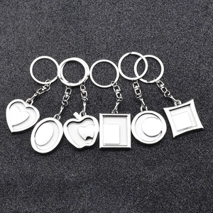 Set of 6 metal keychain frames in various shapes including heart and round for DIY photos