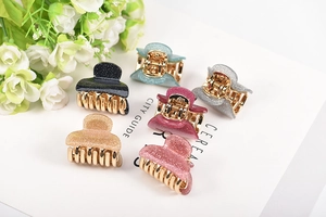 Detailed set of six small glitter acrylic hair claws in assorted metallic colors