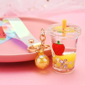 Detail of strawberry milk tea keychain with floating glitter and holographic strap