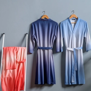 Gradient waffle texture bathrobes in blue, purple and red displayed on wooden hangers