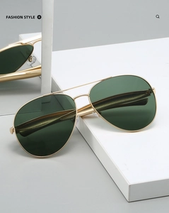 Detailed view of vintage aviator sunglasses with gold metal frames and green lenses