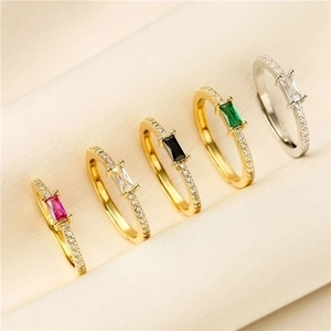 Set of minimalist gold and silver rings with colorful rectangular zircon and micro-pave crystals