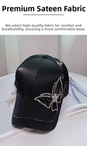 Detail of black satin baseball cap with sparkling rhinestone butterfly decoration