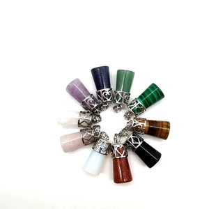 Top view of ten assorted natural crystal pendants in a symmetrical circular arrangement