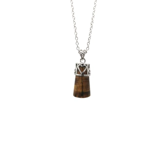 Detailed close-up of tiger eye stone pendant with silver hollow heart metal cap