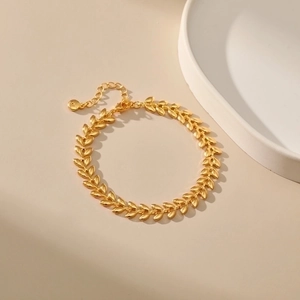 Elegant 18K gold-plated wheat leaf business bracelet with lobster clasp on beige background