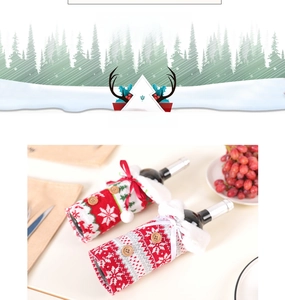 Detail view of knitted Christmas wine bottle covers showing 12cm x 22cm size and soft texture
