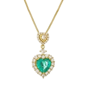 Golden double heart necklace with emerald gemstone and micro-pave diamonds on white background