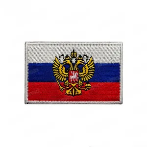 Detailed close-up of embroidered Russian flag patch featuring a golden double-headed eagle