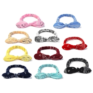 Detailed close-up showing ten different colors of elastic paisley pattern yoga headbands