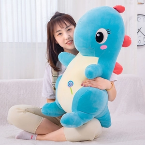 Large blue dinosaur plush toy pillow with colorful lollipop embroidery on soft belly