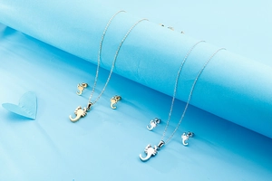 Detail of creative scorpion necklace and stud earring sets in gold and silver finishes