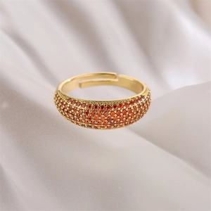 Detail of gold open ring featuring micro-pave set orange-red cubic zirconia stones