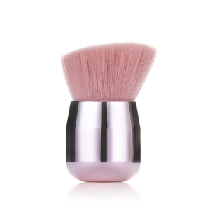 Macro detail of dense pink synthetic bristles on a mushroom-style angled makeup brush