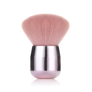Macro detail of soft pink mushroom makeup brush head with metallic handle and soft bristles