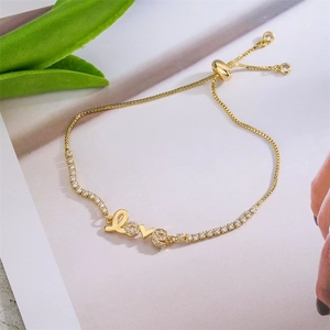 Detail of adjustable gold LOVE bracelet with sparkling pavé cubic zirconia accents