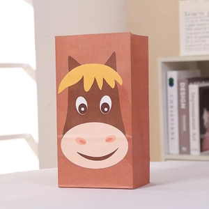 Close-up of brown paper gift bag with cartoon horse print and stickers on light surface