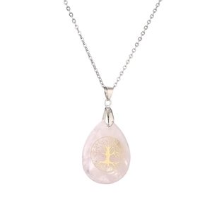 Pink teardrop gemstone necklace with golden tree of life pendant on silver metal chain