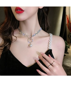 Close-up of sparkling rhinestone choker necklace with a white pearl pendant on model