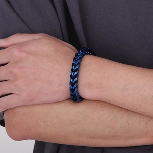 Close-up of blue plated stainless steel wheat link chain bracelet on male wrist
