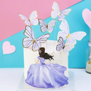Purple princess and gold-edged butterfly cake toppers set on white cake