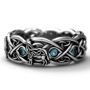 Vintage silver Celtic wolf ring featuring blue gemstones and intricate woven knot designs