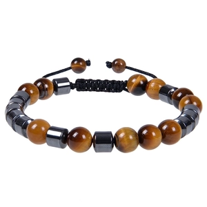 Detailed macro view of adjustable tiger eye and hematite beaded bracelet on woven rope