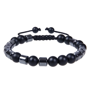 Detail of adjustable braided cord and matte black stone beads on masculine bracelet