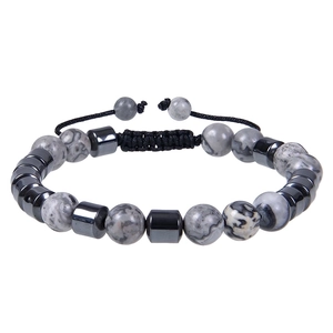Detail of handmade adjustable braided bracelet with natural map stone and hematite beads