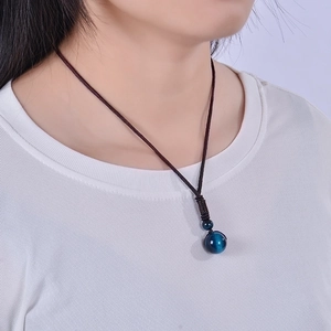 Minimalist 16mm blue tiger eye stone pendant necklace with brown braided rope on model