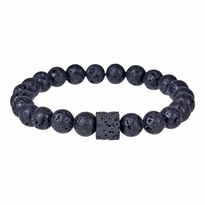 Macro detail of natural black lava stone beads and cubic bead on a minimalist bracelet