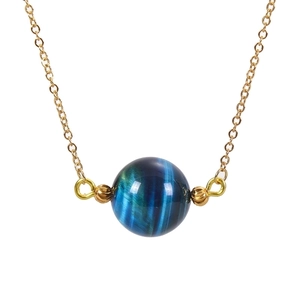 Macro detail of 16mm blue tiger eye stone pendant with gold chain showing cat eye effect