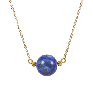 Detailed macro view of 16mm round blue lapis lazuli stone pendant on a gold link chain