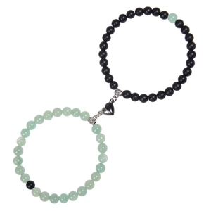 Detail of pink zebra stone heart magnet bracelets for couples with interlocking design