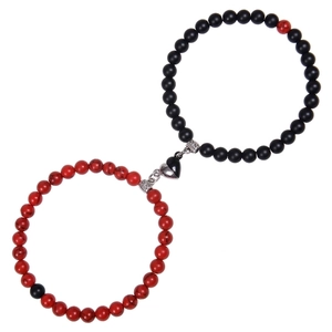 Detail of pink zebra stone couple bracelets with magnetic heart charm and beads