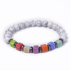 Macro shot of white marble beads with colorful cubic stones and hematite spacers